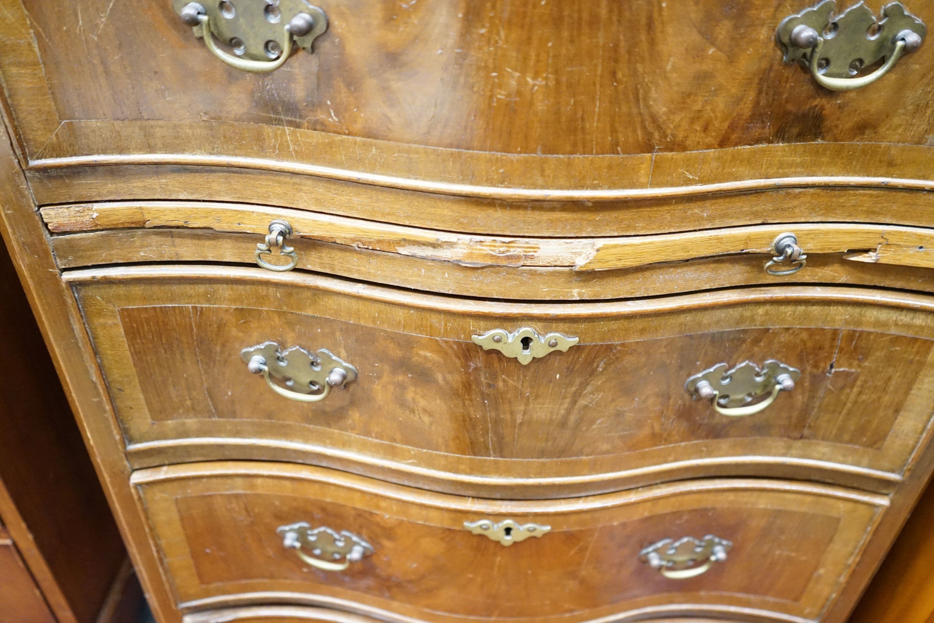 A reproduction 18th century style serpentine walnut tall chest fitted slide, width 66cm, depth 43cm, height 134cm